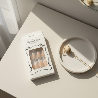 Packaged nude press-on nail set on a minimal vanity surface