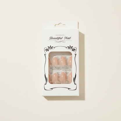 Packaged glossy nude press-on nail set on a clean studio background